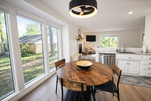 A charming dining nook bathed in natural light from the surrounding windows.