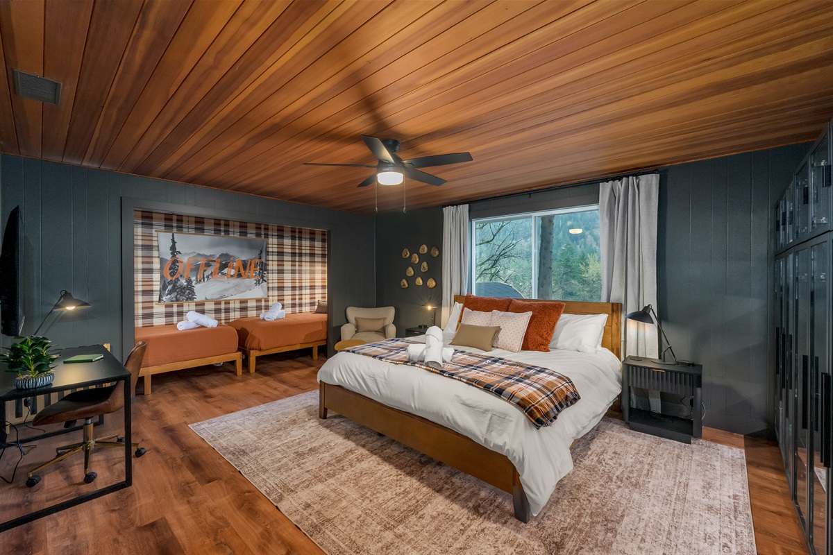 Retreat to your private king suite with an ensuite bathroom, where warm textures and two additional twin beds create a beautifully flexible, upscale sanctuary.