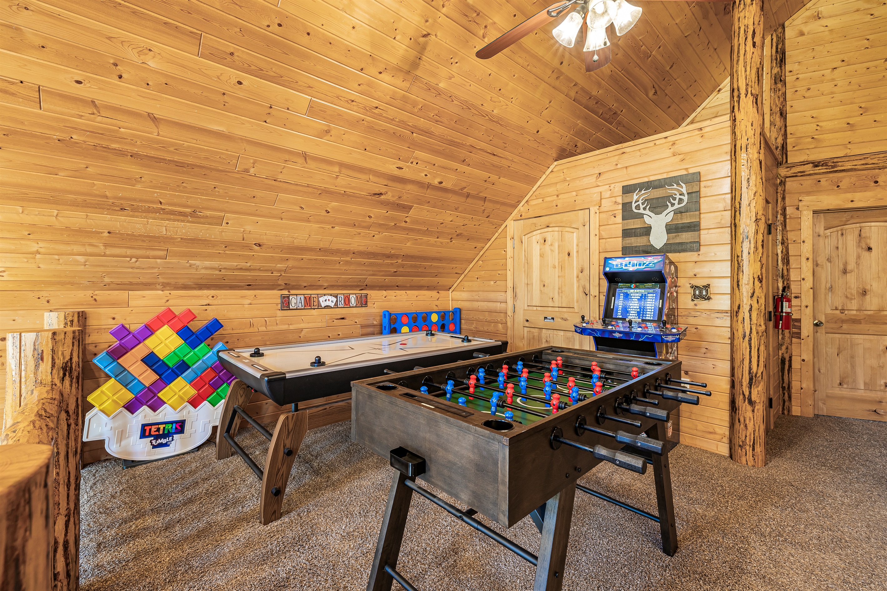 Upstairs game area w/ air hockey, foosball table, and arcade