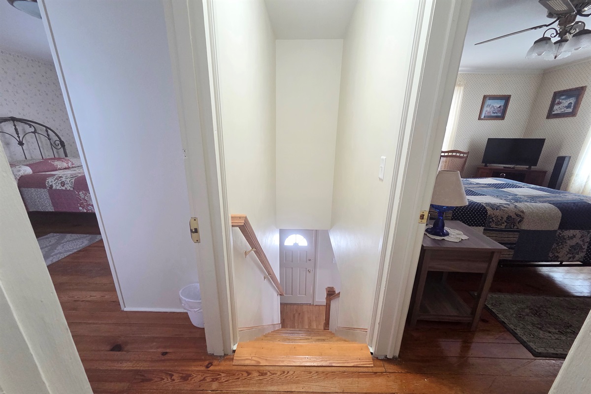 A set of steps inside the house leads to the upstairs bedrooms and bathrooms, adding to the home’s cozy layout.