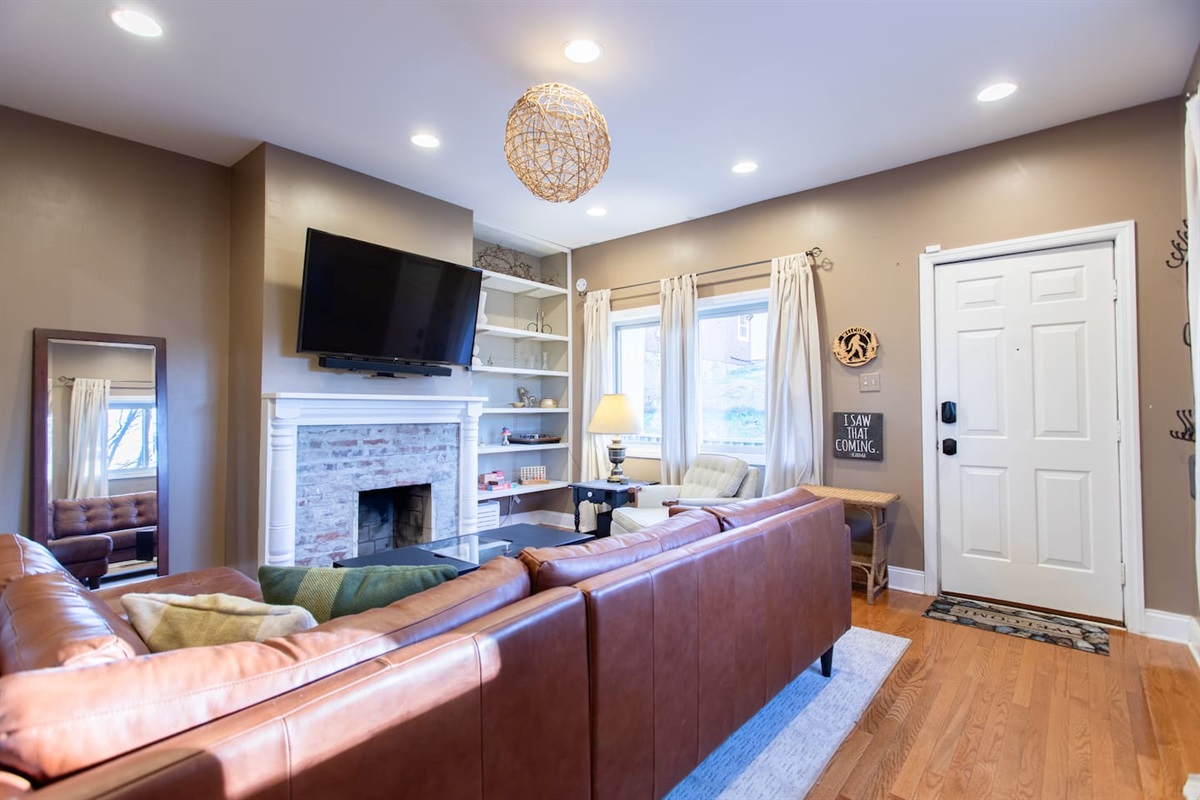 Cozy modern living room, a mounted smart TV, and layered textures that create a warm, inviting space.
