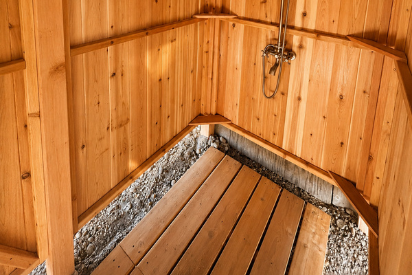 Convenient enclosed outdoor shower provides a refreshing rinse after swimming and beach adventures.