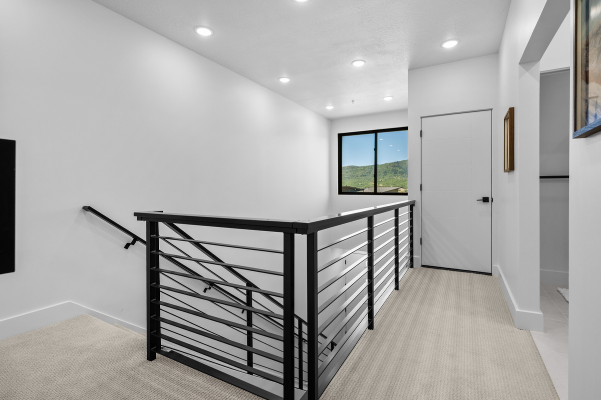 Open upper hallway leading to the upstairs bedroom and bathroom.