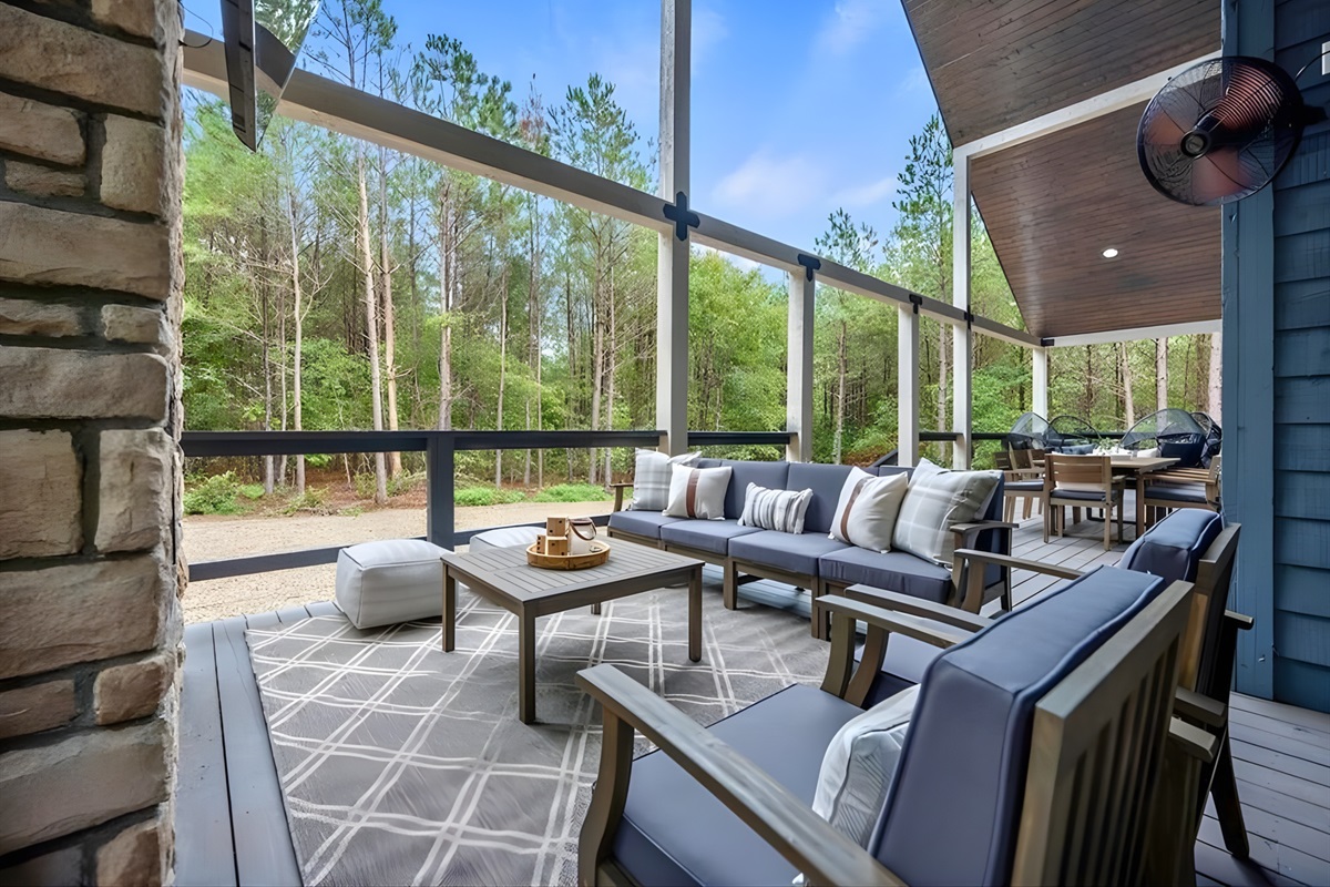 Stretch out on the cushioned patio seating and enjoy the peaceful forest stretching out around you.