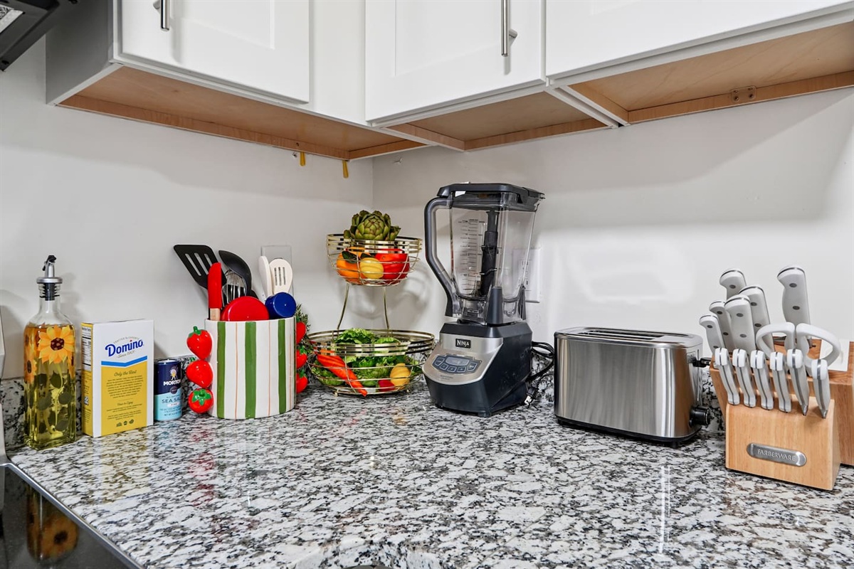 Full kitchen thoughtfully stocked with everything you may need including cookware, utensils, dishes, and essential appliances perfect for preparing meals and enjoying a true home-away-from-home experience.