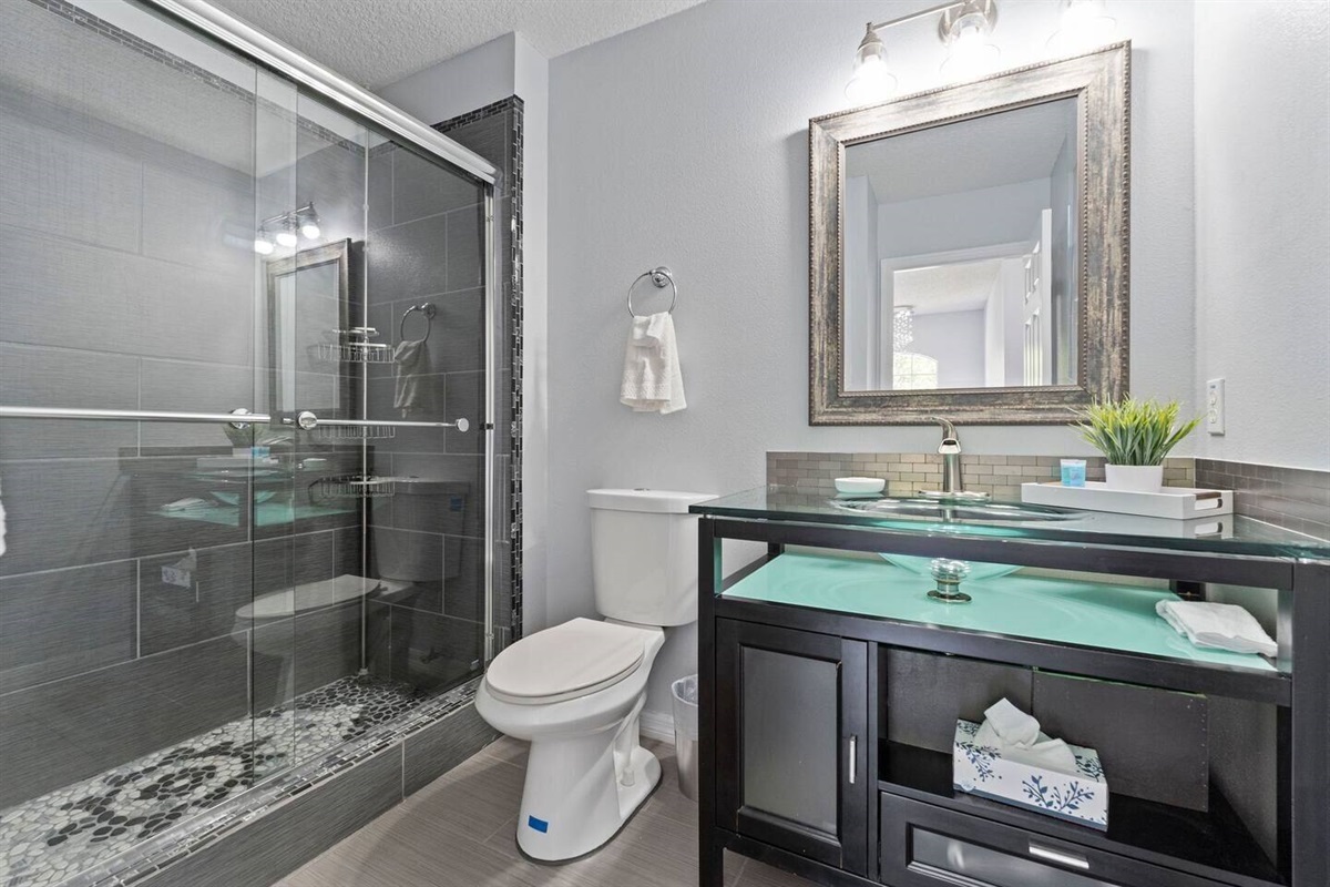 The full bathroom has a walking shower