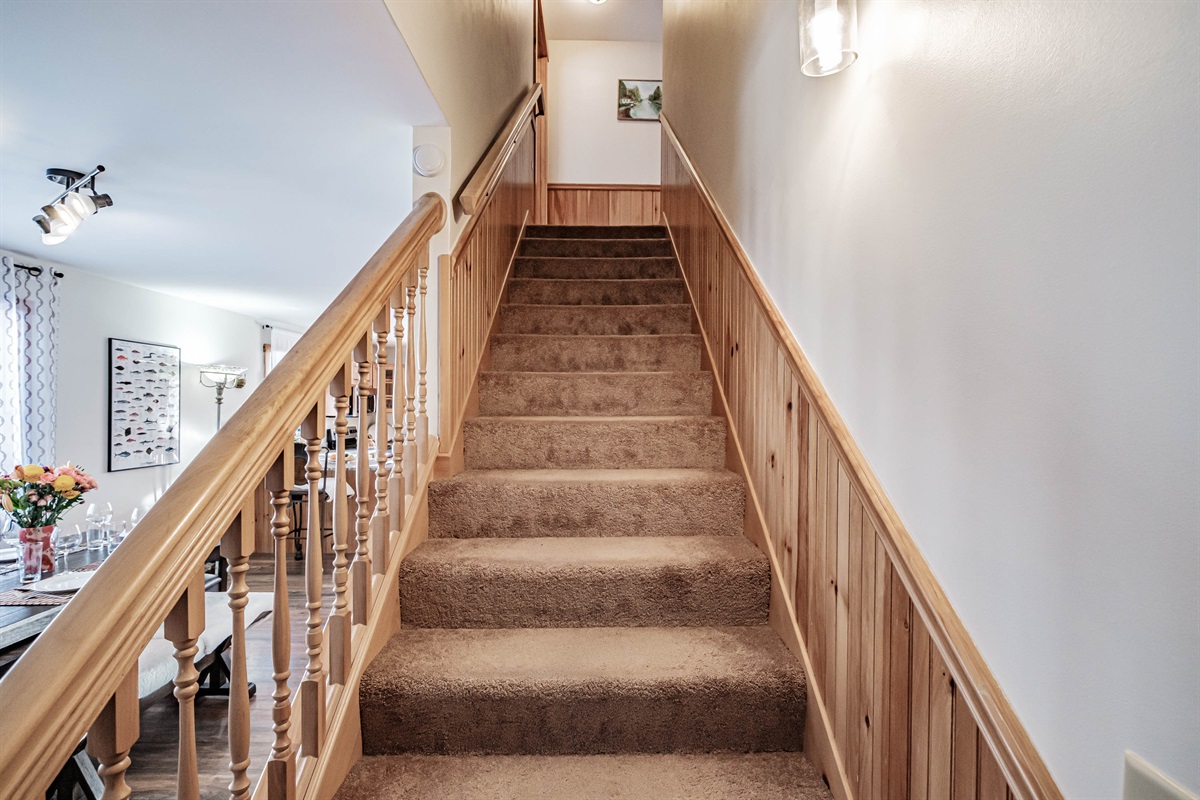 A sturdy staircase with natural wood finishes guides you to the second floor.  Emotional & Inviting: