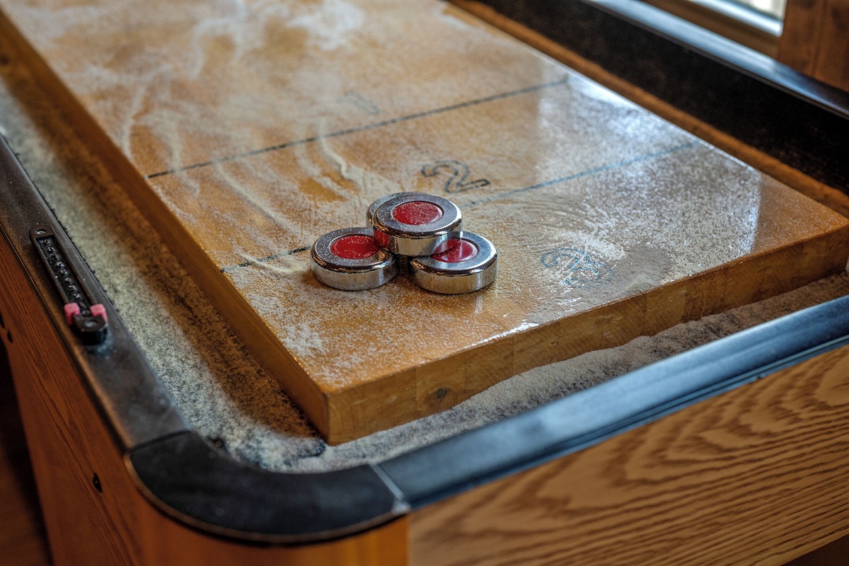 Table shuffle board in game room
