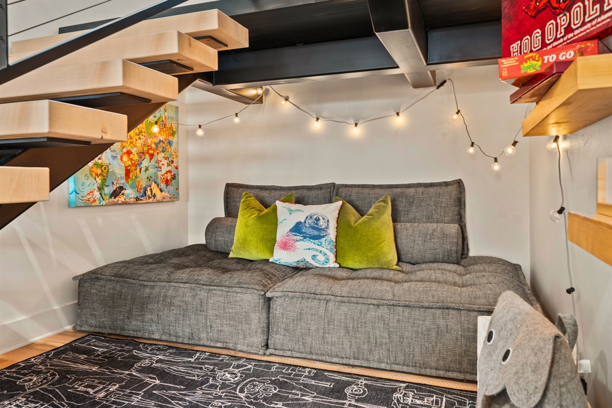 Enjoy a quiet moment in this cozy nook, complete with comfortable seating and whimsical decor.