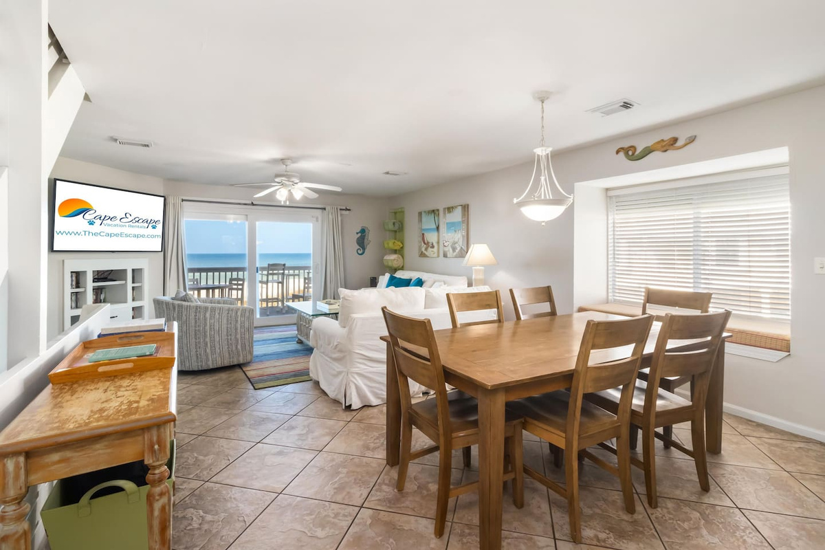 Pull up a chair at the dining table, slide into the bay window seat, or take a bar stool &mdash; the main level fits the whole group.