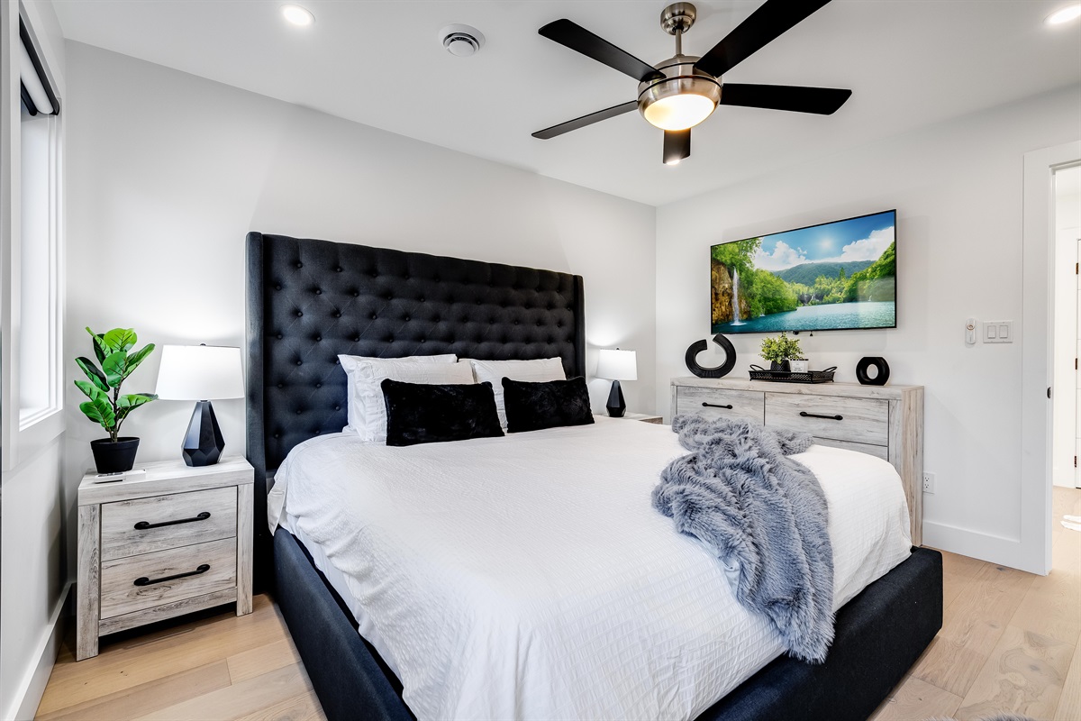 King Bedroom with Natural light highlights the deep brown furniture accents.