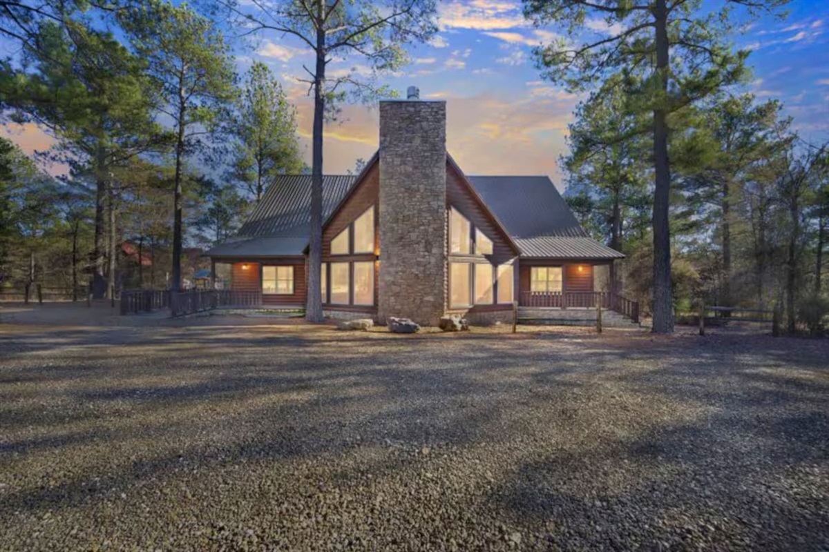 Golden‑hour glow on timber beams and treetops.