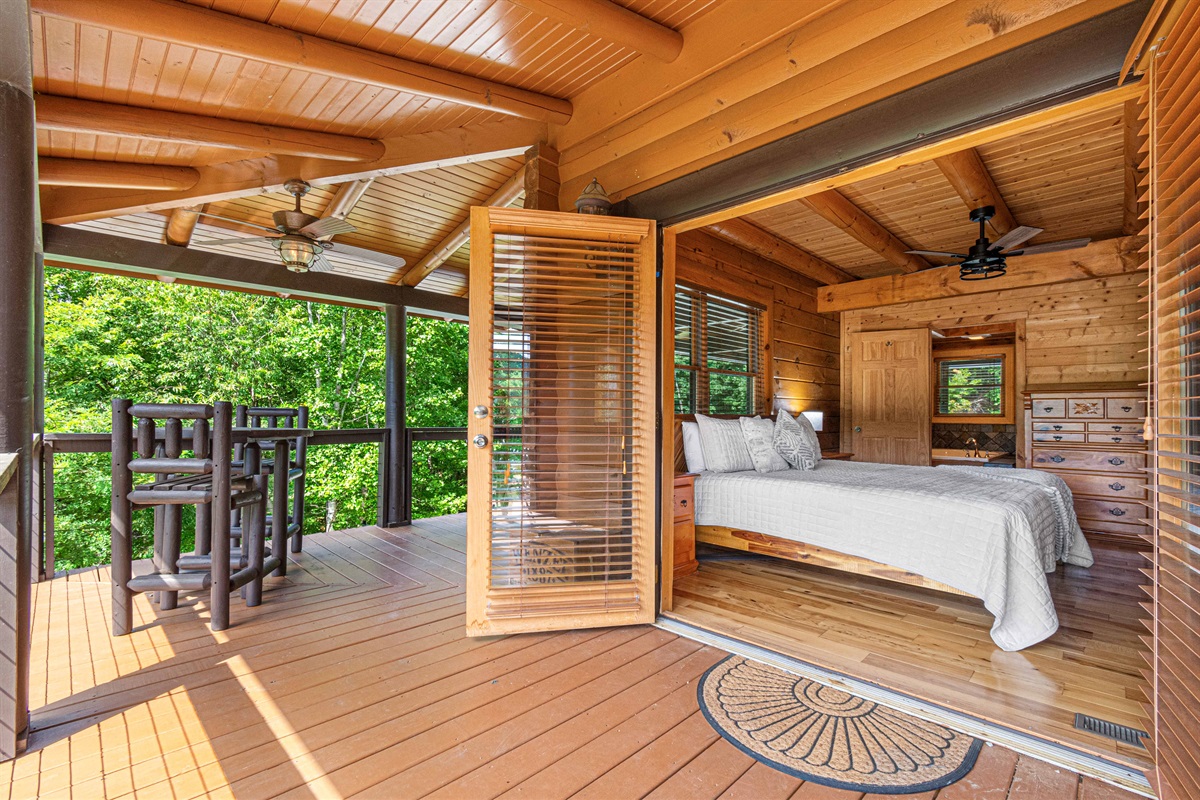 Main Level Master Bedroom: Enjoy tranquil views and fresh air from your private balcony retreat!