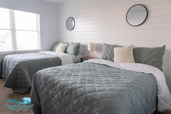 This newly renovated double bedroom has a cozy costal feel. 