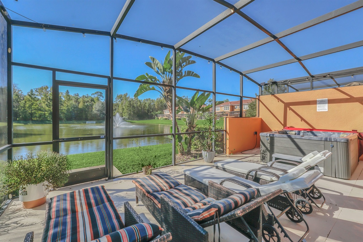Private covered lanai with seating area, hot tub and lounge chairs