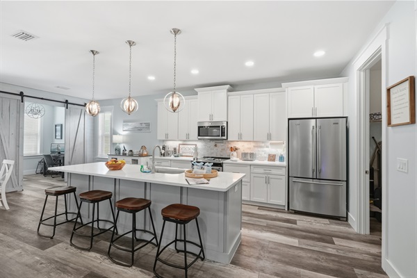 Sit back at your huge island and eat in kitchen with your favorite drink, a charcuterie board and friends and family as you prepare for your family meal.