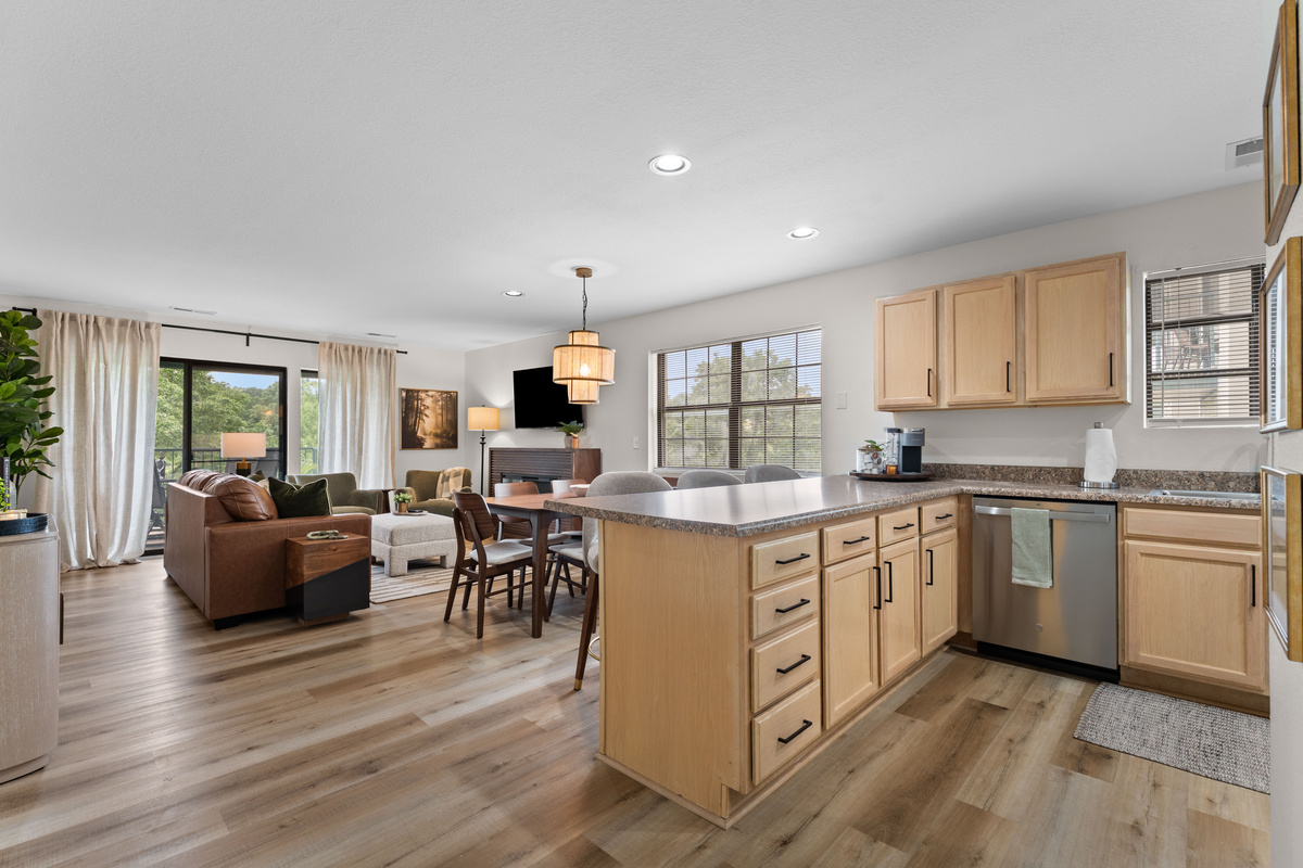 The full kitchen is open to the dining and living areas and stocked for preparing meals at home.