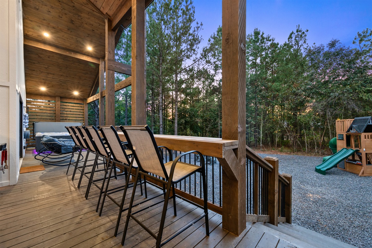 Bar seating on the back porch offers the best seat in the house for conversation and evening views.