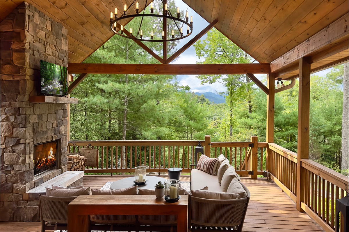 Cozy up by the outdoor fireplace, sip your favorite drink, and take in the breathtaking views from this dreamy covered deck.