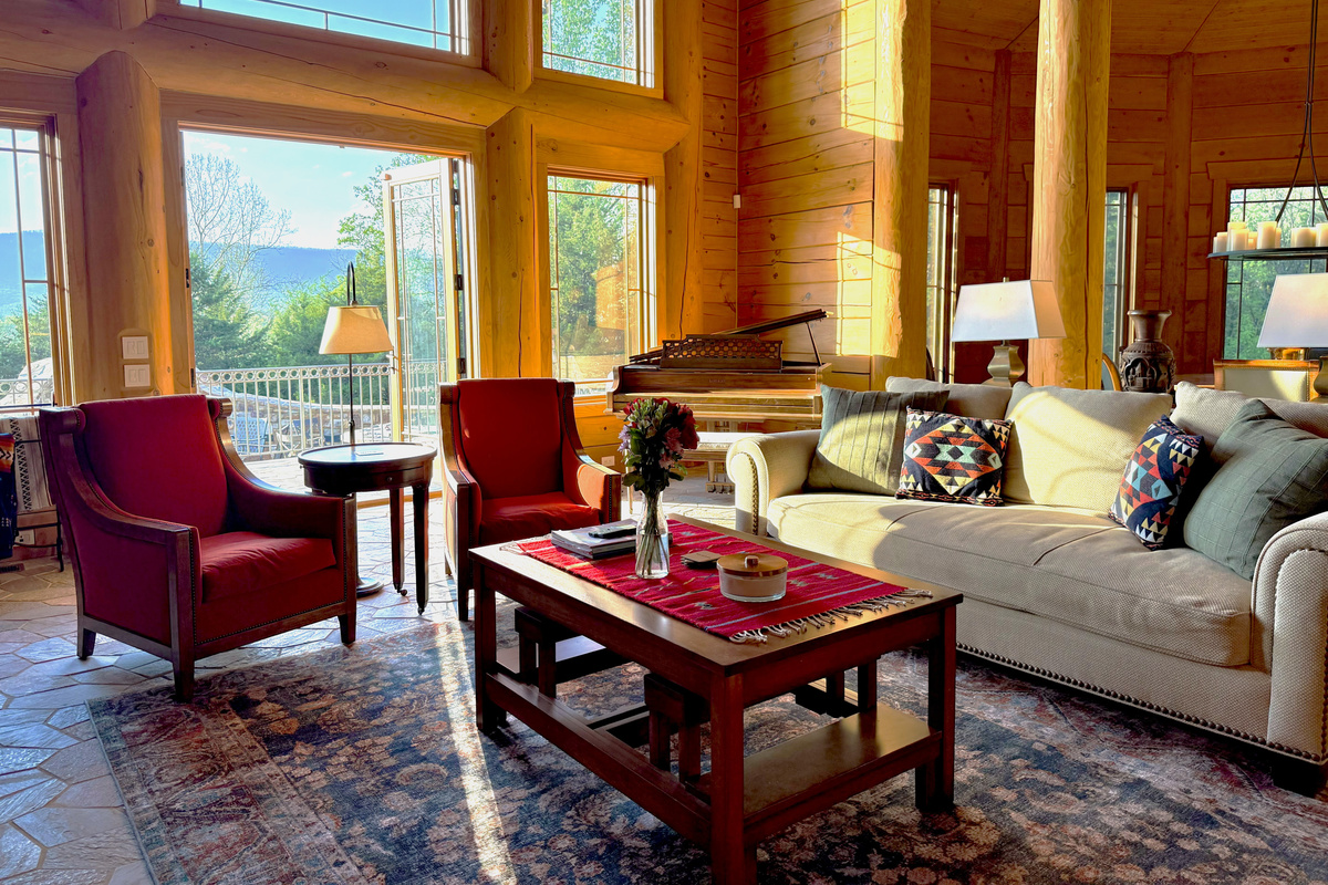 Bright living room with a large propane fireplace and stunning views throughout