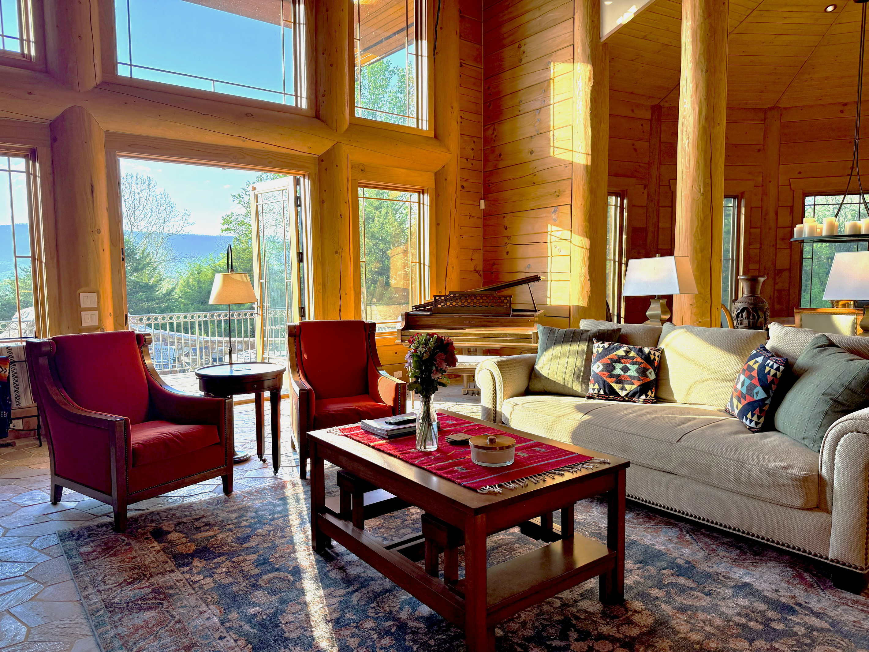 Bright living room with a large propane fireplace and stunning views throughout