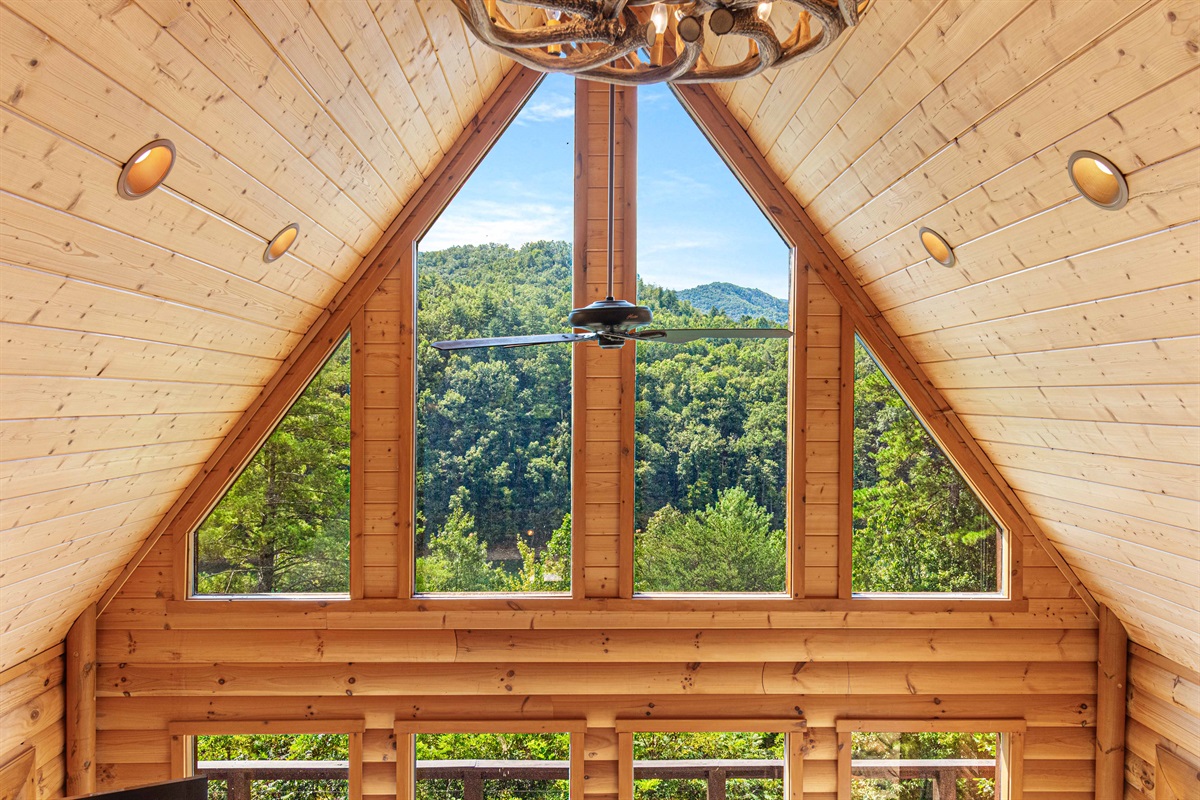 View from Upstairs: Experience breathtaking mountain views in this airy wood-paneled haven!