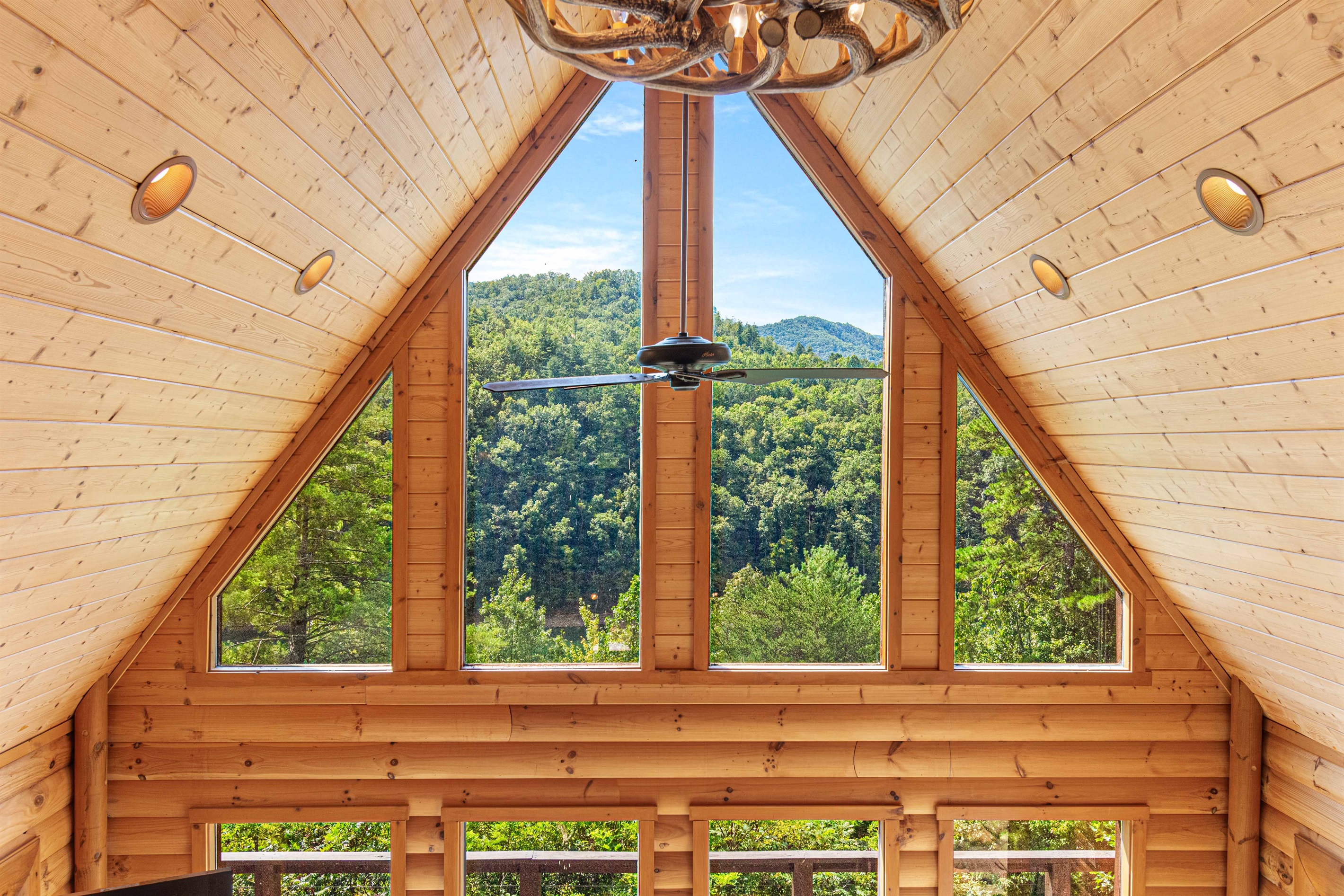 View from Upstairs: Experience breathtaking mountain views in this airy wood-paneled haven!