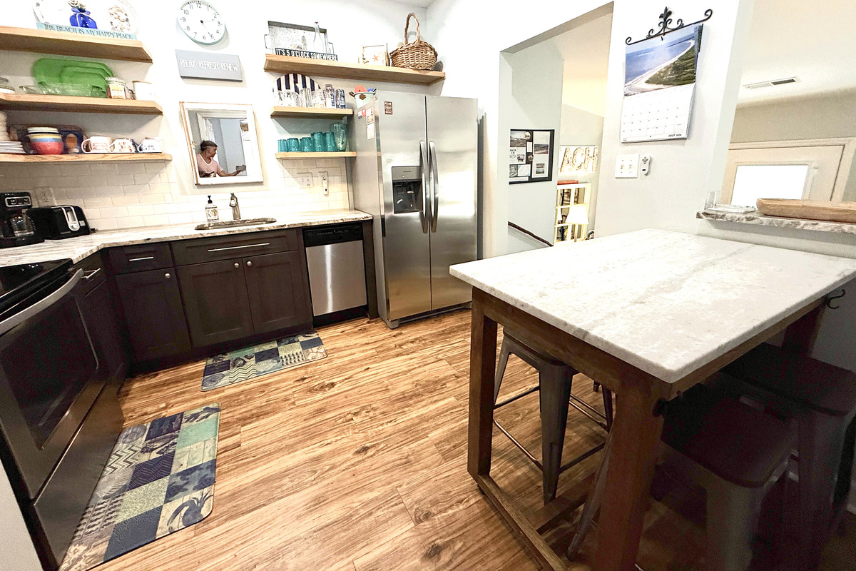 Pass-though window between kitchen and living.  Island on wheels for eating together or for use as counter space for preparing meals.