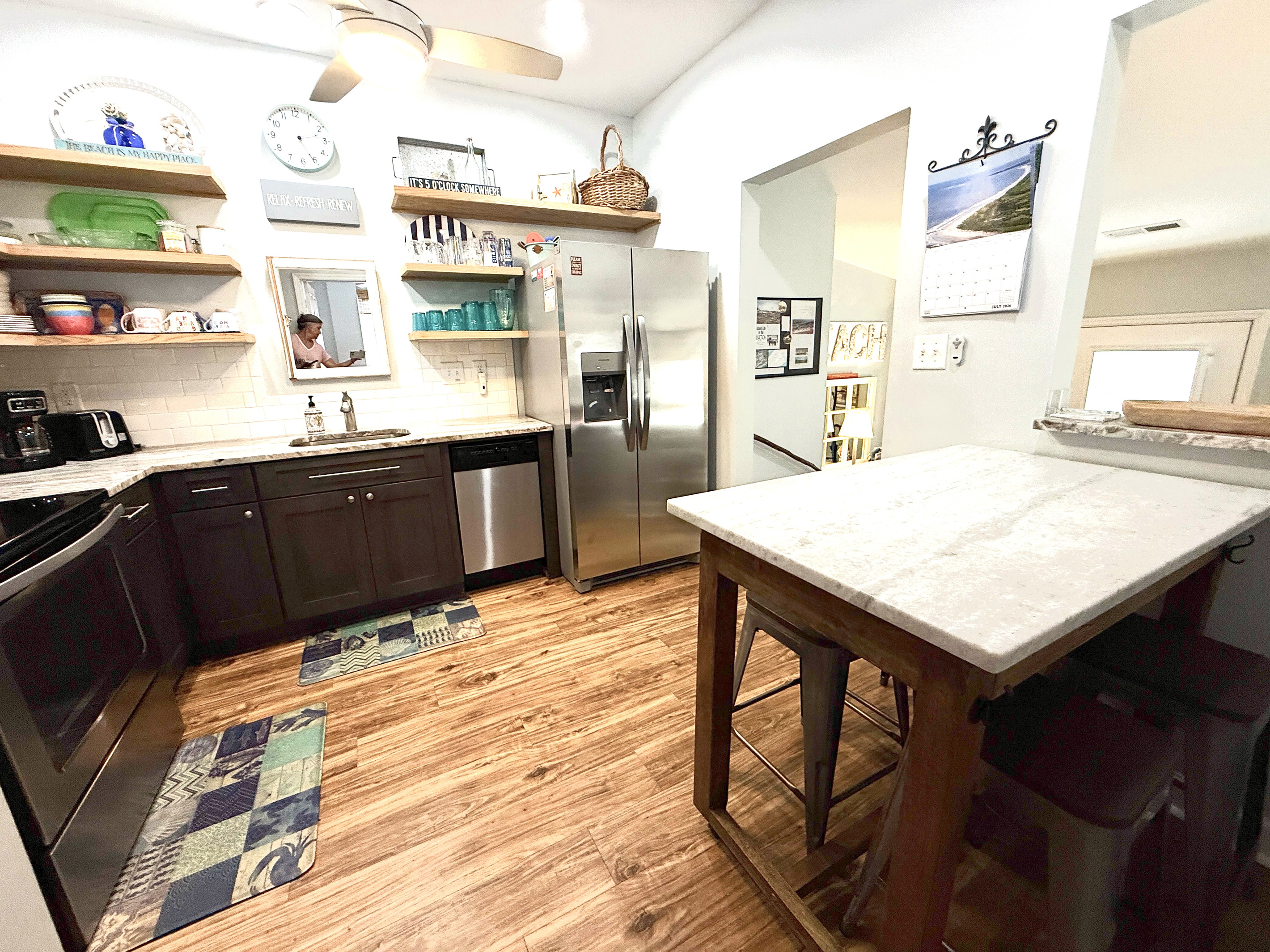 Pass-though window between kitchen and living.  Island on wheels for eating together or for use as counter space for preparing meals.