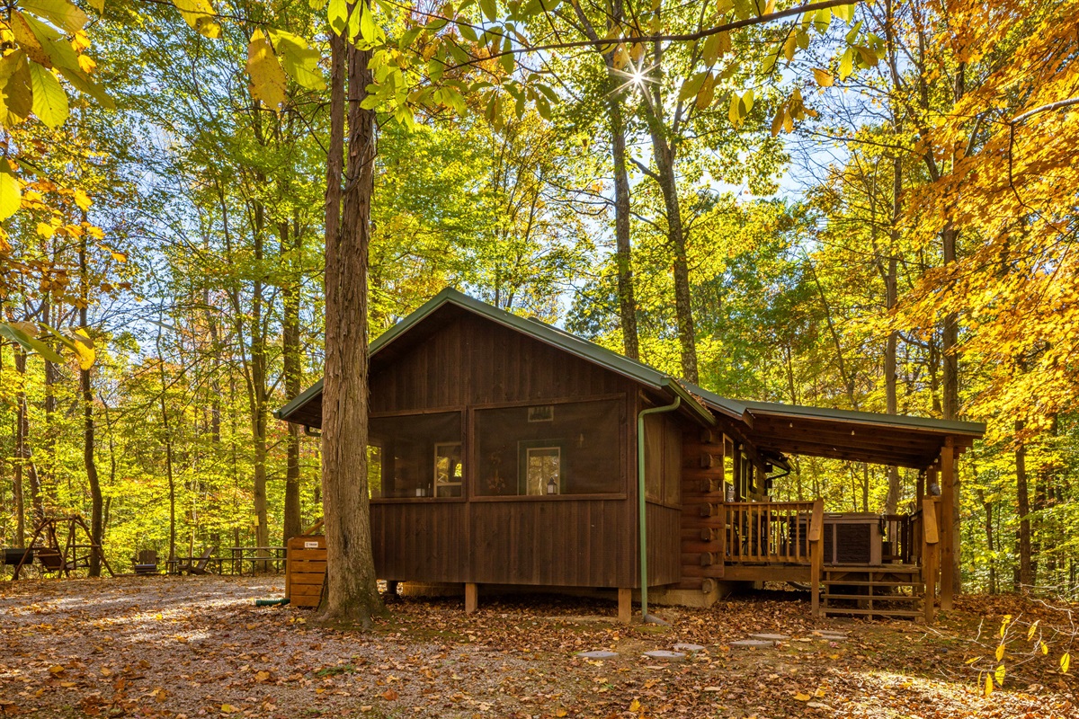 Fall view of cabin and covered hot tub area