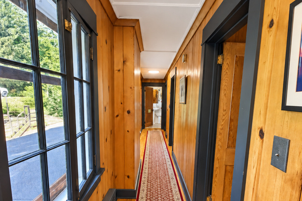 2nd floor hallway w/ doors to each of the three separate 2 bedroom suites
