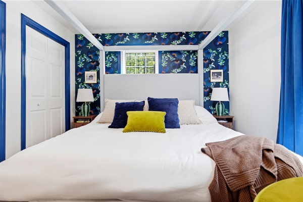 A comfortable and inviting king bed designed for restful sleep and quiet relaxation in a calming atmosphere.