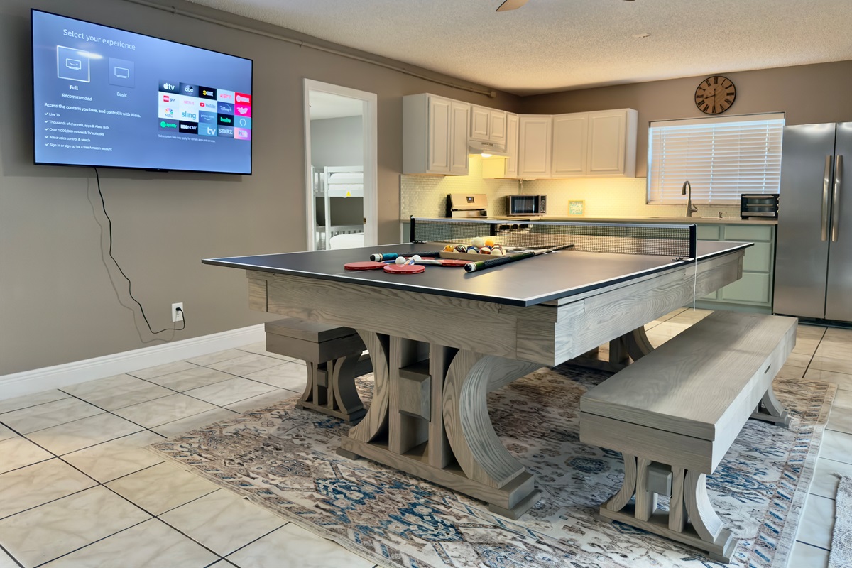 The room is thoughtfully designed with soft neutral tones, tile flooring for easy cleanup, and a ceiling fan to keep you cool while the action heats up.
