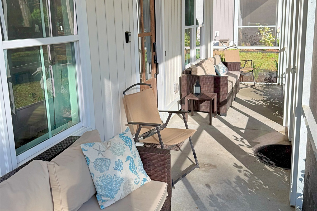 There are lots of seating options in the screened-in porch.