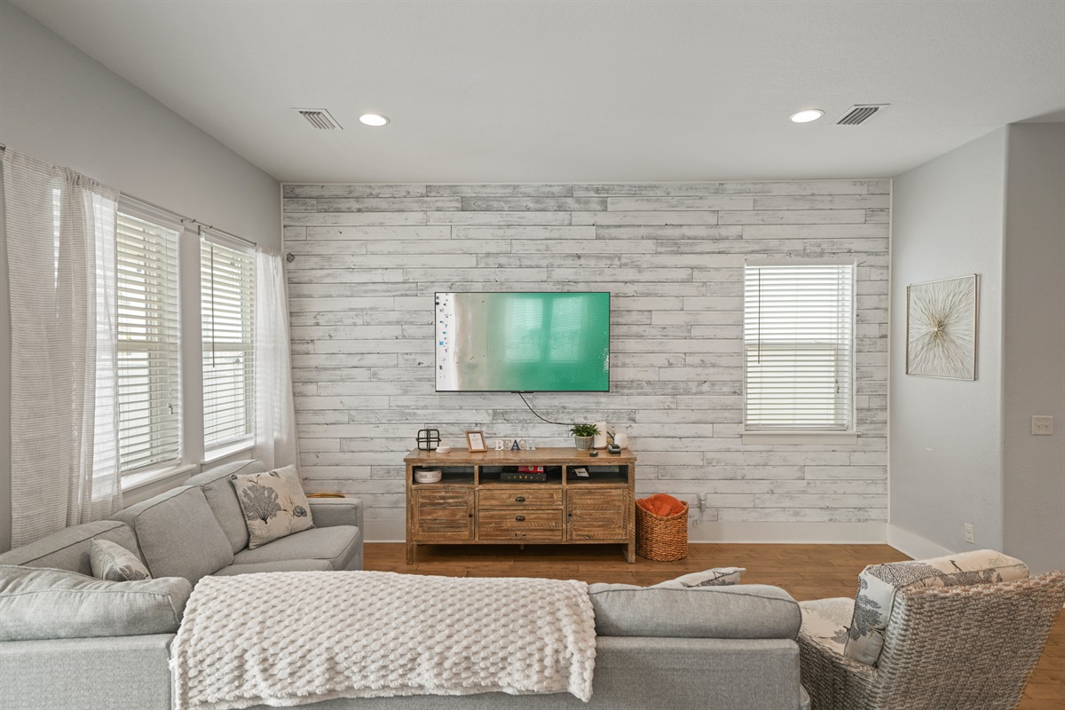 Bright living area with coastal accents and plenty of natural light.
