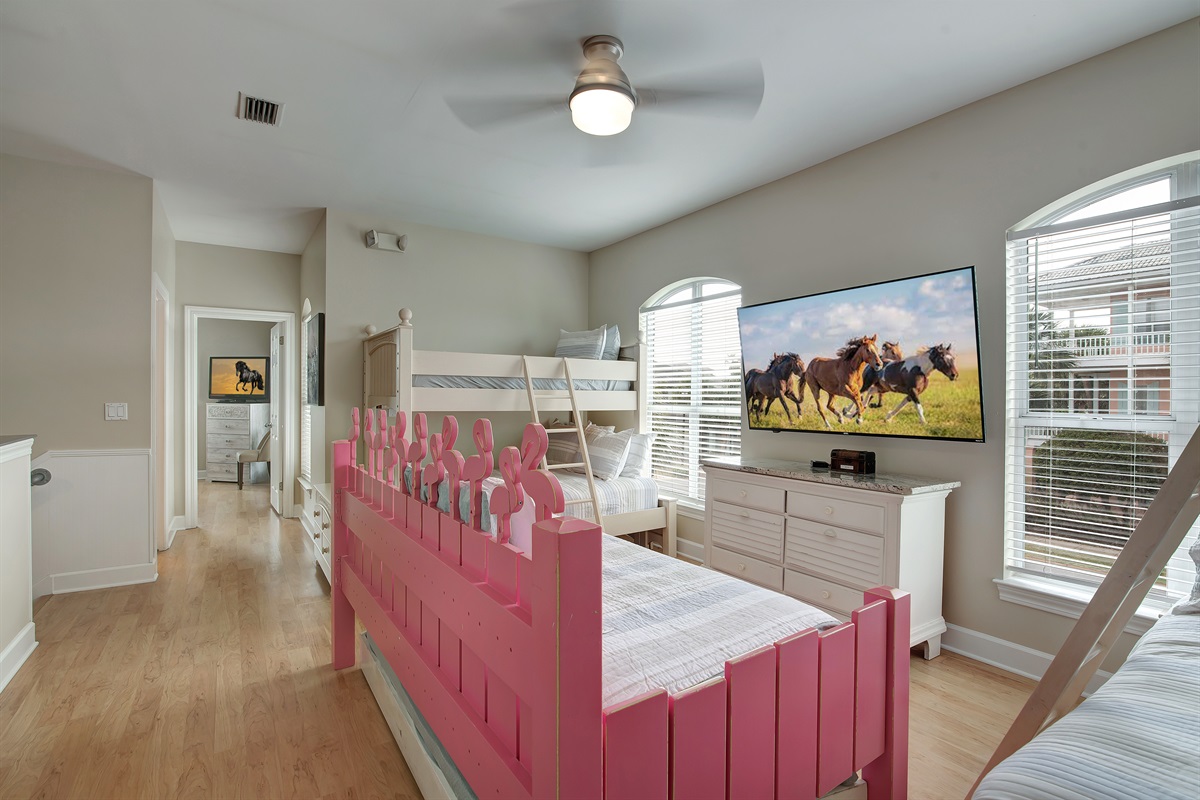 Bunk room with playful pink bunks and Smart TV