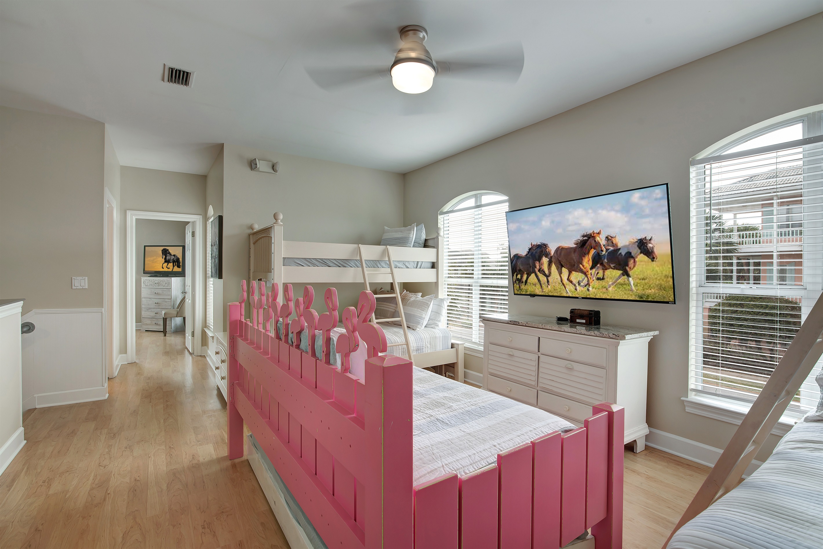 Bunk room with playful pink bunks and Smart TV