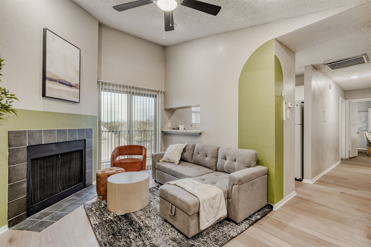 Cozy modern retreat with a fireplace and natural light.