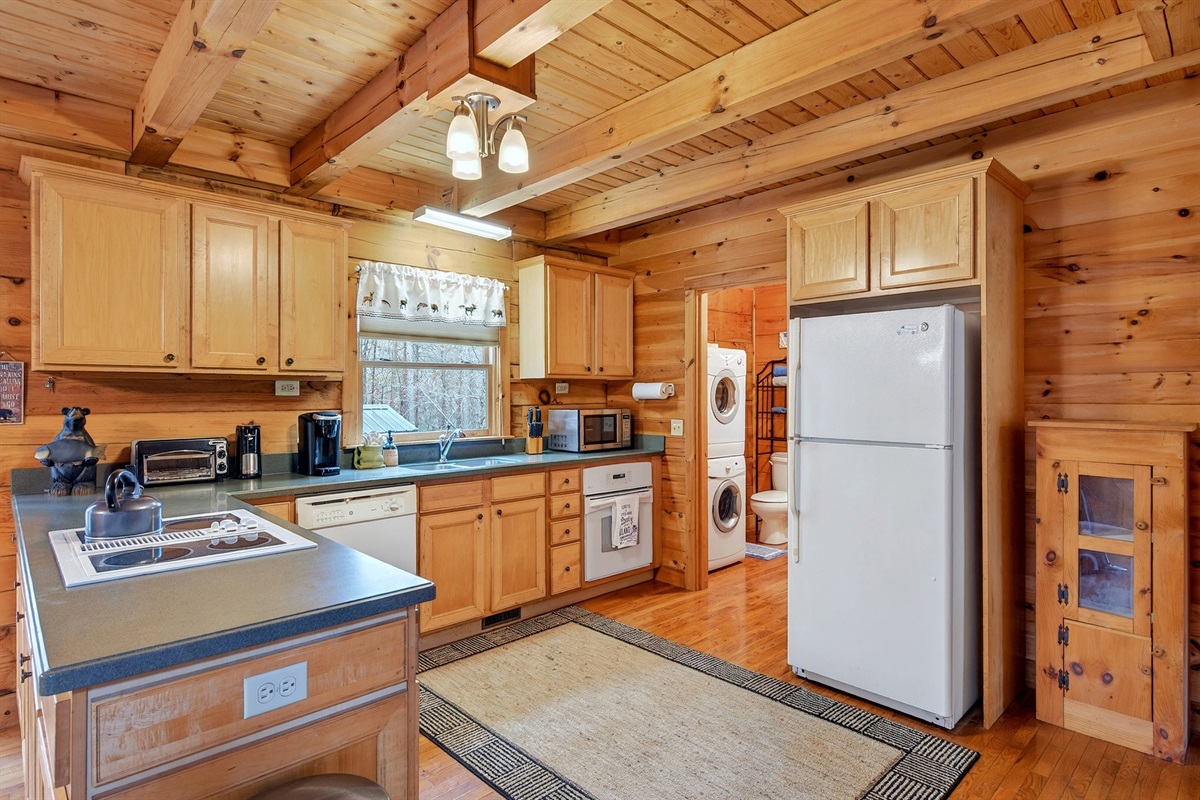 The kitchen includes a refrigerator with working ice maker, dishwasher and microwave 