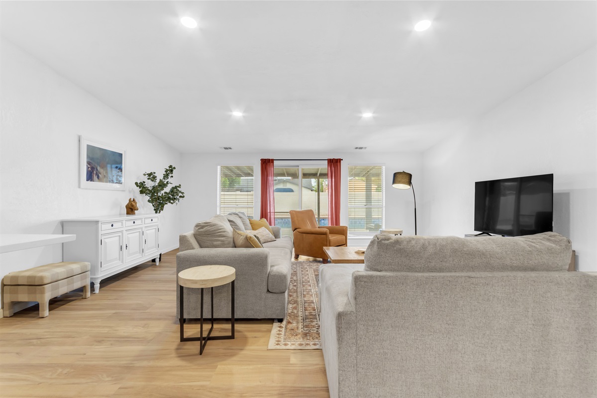 Spacious and stylish, this bright living room offers the perfect space to relax with comfortable seating and a large smart TV