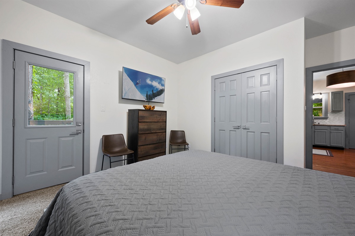 The downstairs bedroom is complete with a smart TV, a private balcony, and a closet!