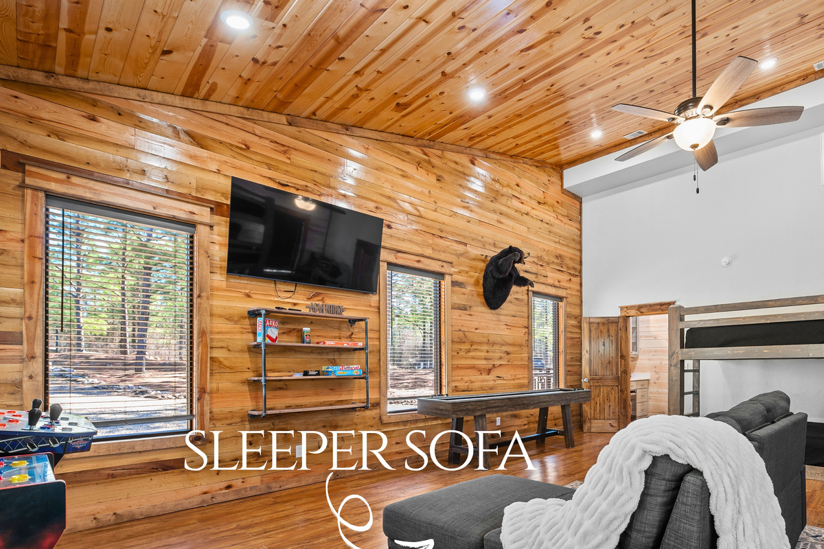 This cozy bunkroom doubles as a lounge area, complete with a sleeper sofa for extra comfort and flexibility.