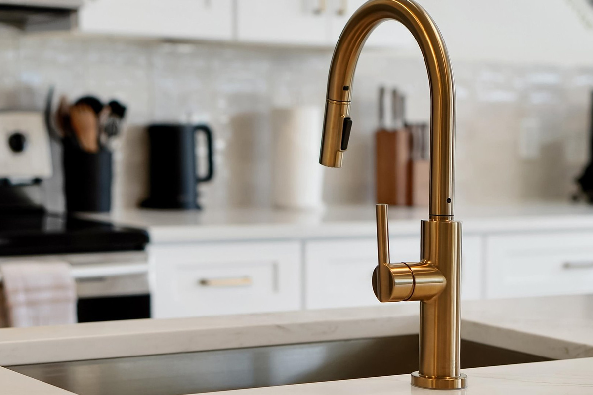 Kitchen Detail: Modern pull-down faucet and deep stainless-steel sink in the spacious kitchen island.