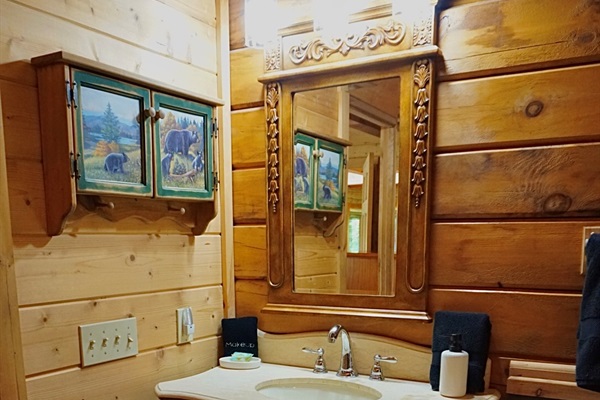 Rustic elegance. This charming bathroom vanity adds a touch of mountain style to your stay.
