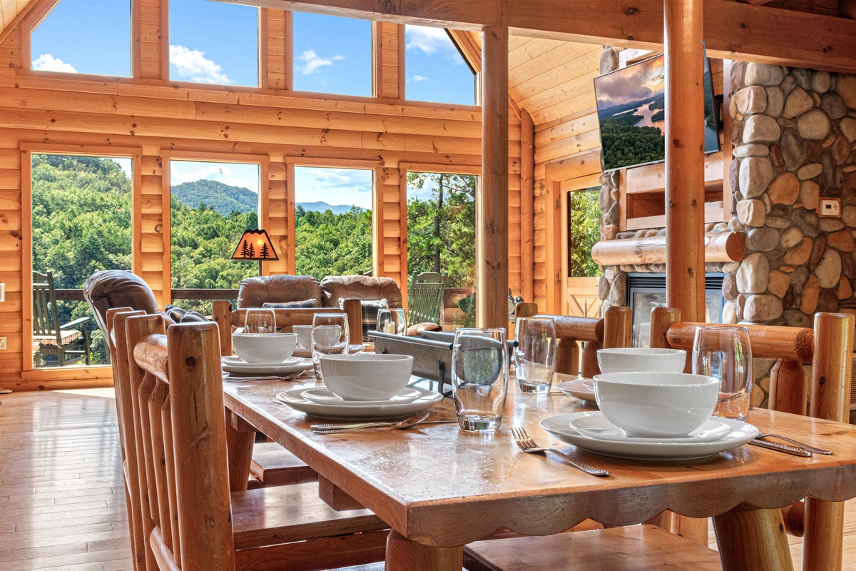 Main Level Dining Room: Indulge in mountain views while savoring meals at this stylish log cabin dining oasis!