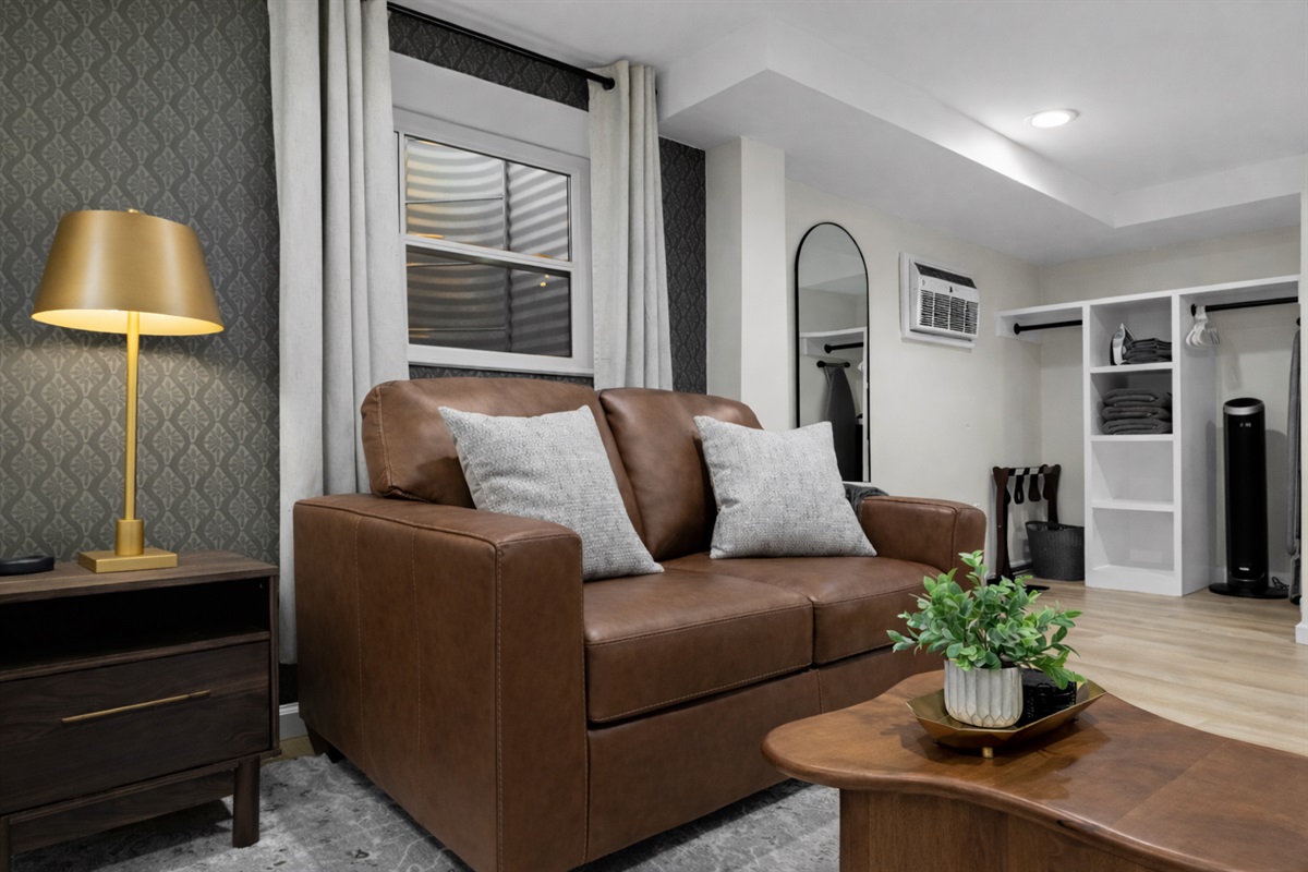 Cozy lounge area with comfortable leather seating, warm accent lighting, and stylish details—an inviting spot to relax, unwind, and feel right at home.