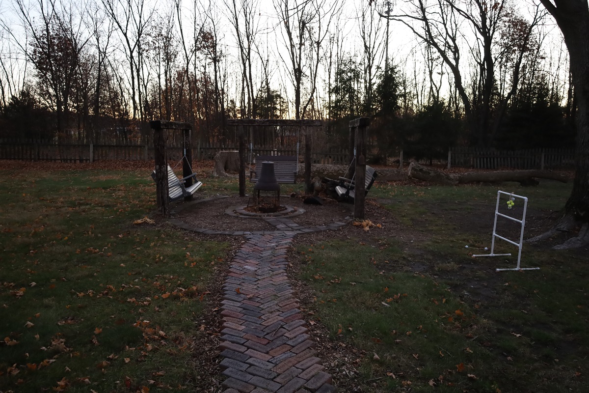 fire pit and swings in the yard