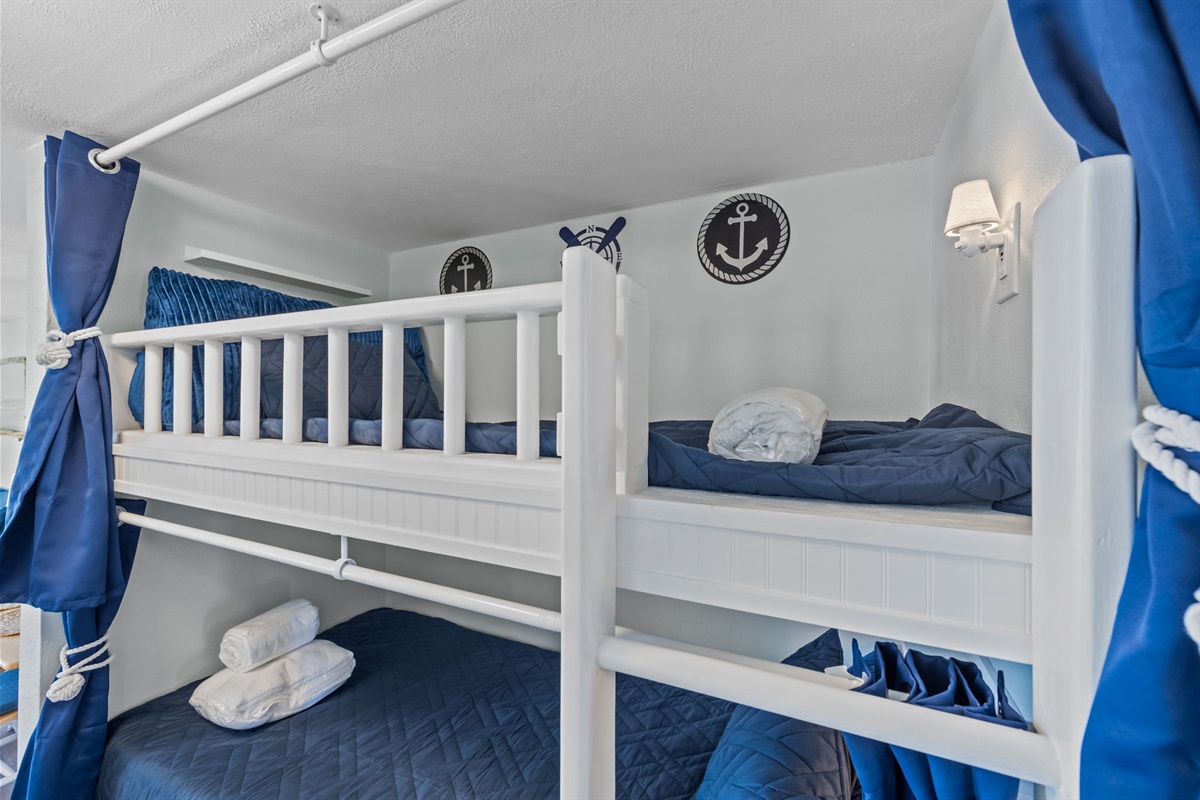 Nautical-inspired bunk nook with cozy bedding and thoughtful details throughout