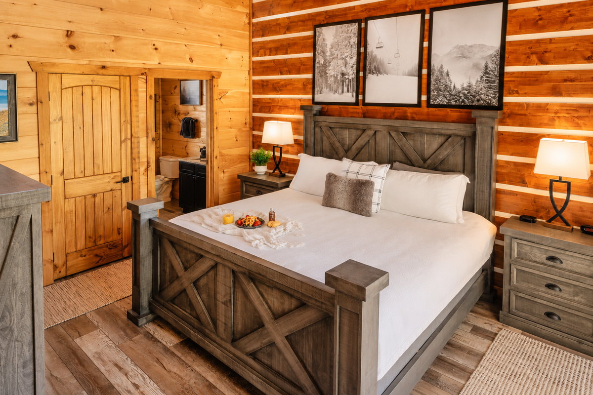 Barn-style king frame, matching nightstands, dresser, and a connected bathroom.