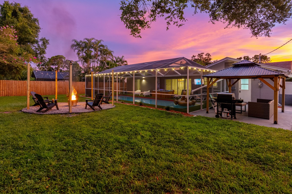 Watch the sky light up with color as the fire crackles—this serene backyard setup is the kind of place memories are made.